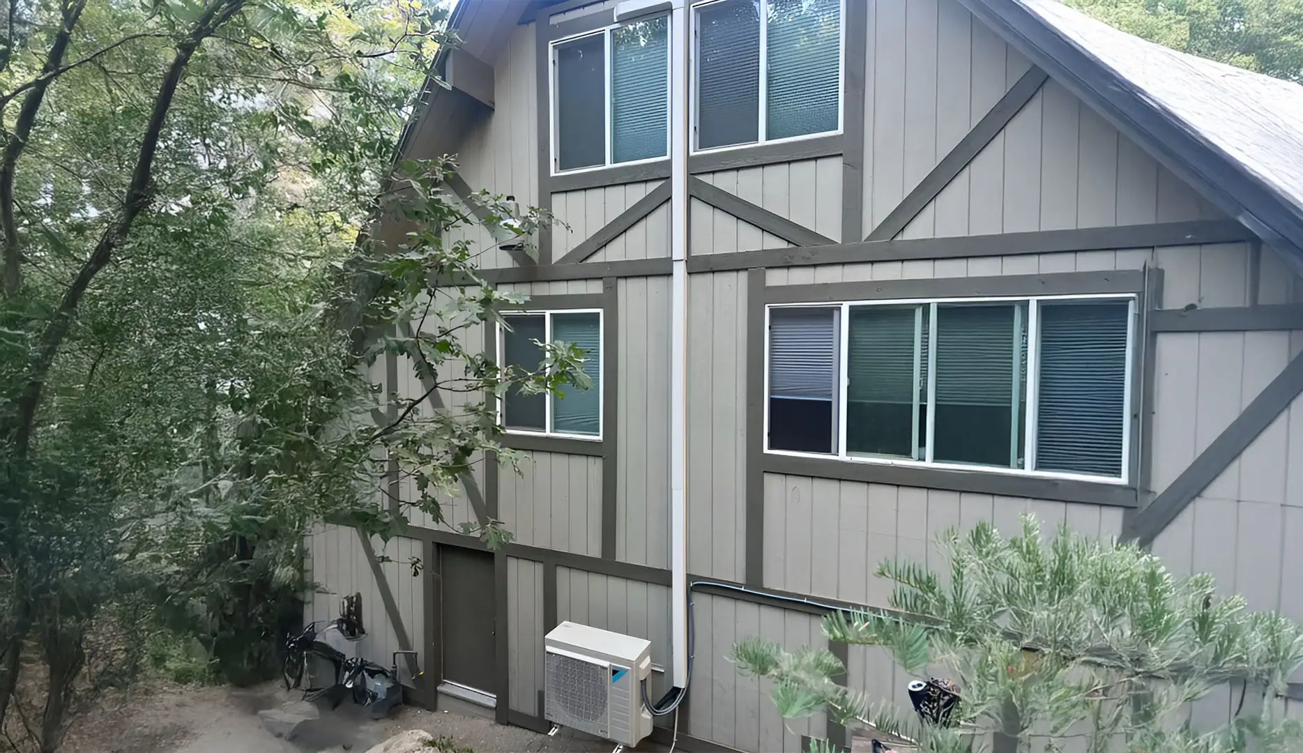 Ductless air conditioning system set up outside a three story home, just outside the door leading to the basement.