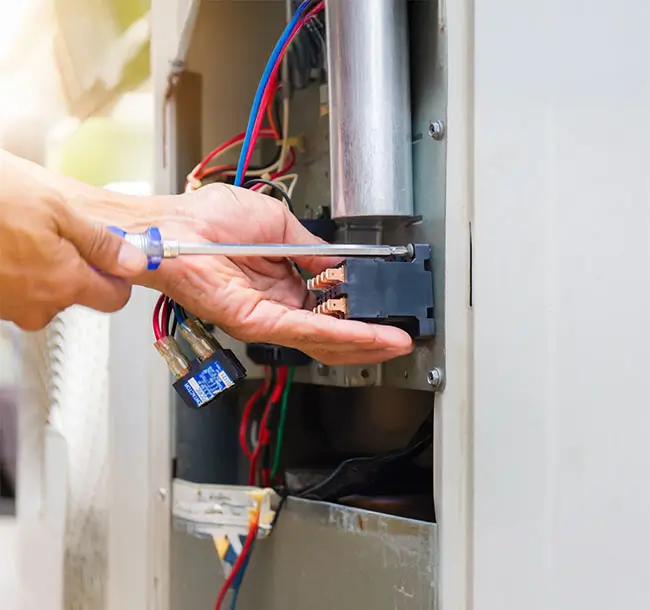 Gas Heater Repairing Performed by Caucasian Technician.
