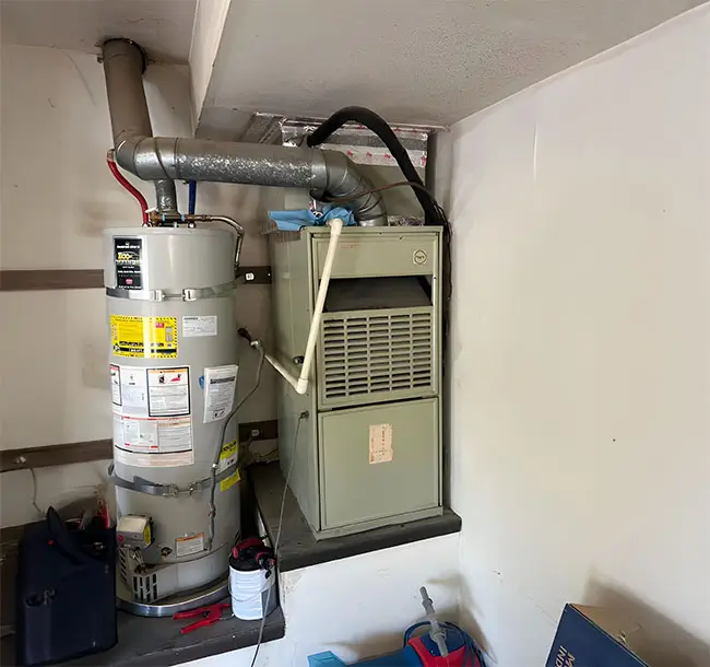Heater in a basement next to a broiler.