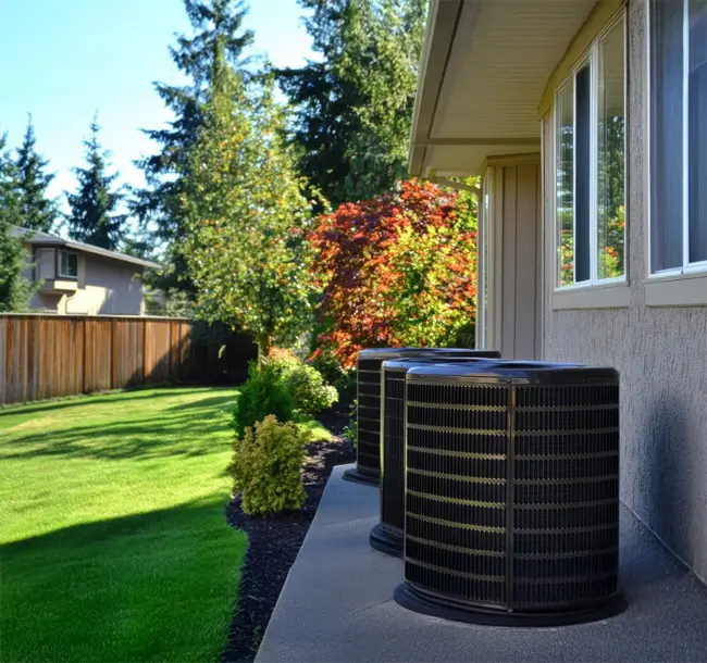 Outdoor installation of central air conditioning units for residential properties installed outside a house.