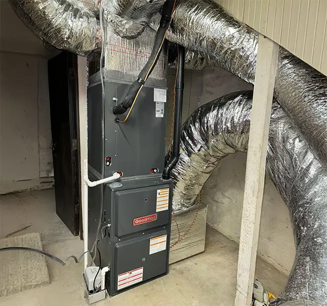 Heater in a basement with ductwork.
