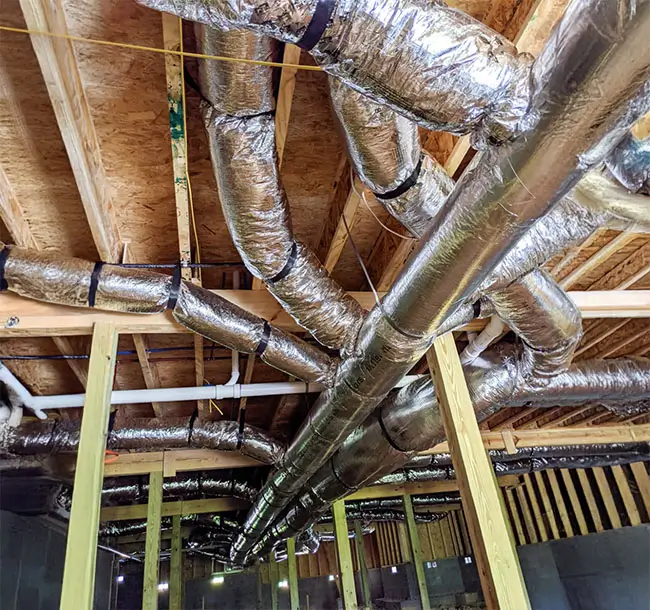 The art of HVAC ductwork in a residential crawl space.